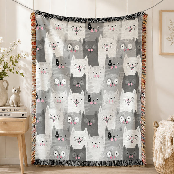 Grey Kawaii Cat Woven Throw Blanket on a made bed