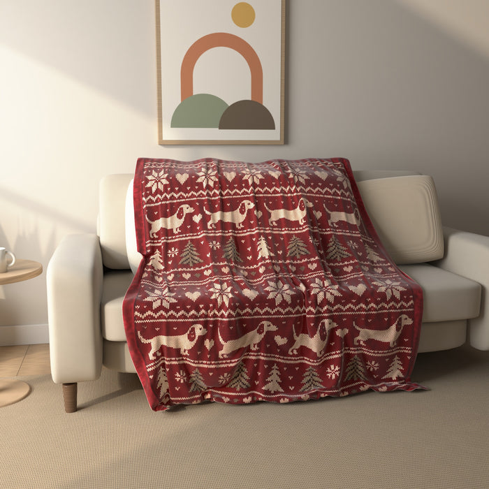 Fair Isle Dachshund Christmas fleece throw blanket draped over a sofa