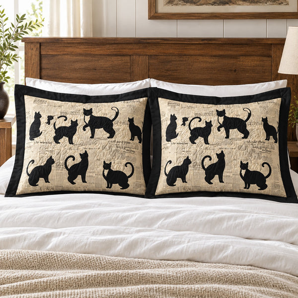 Newsprint Black Cats pillow shams – set of two flanged shams against a wooden headboard