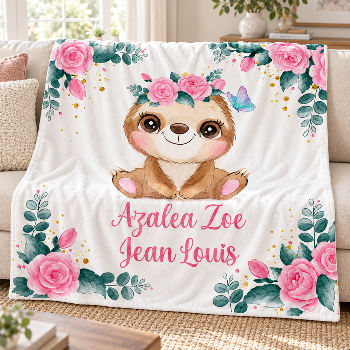 Baby sloth personalised name blanket with pink roses, on a sofa