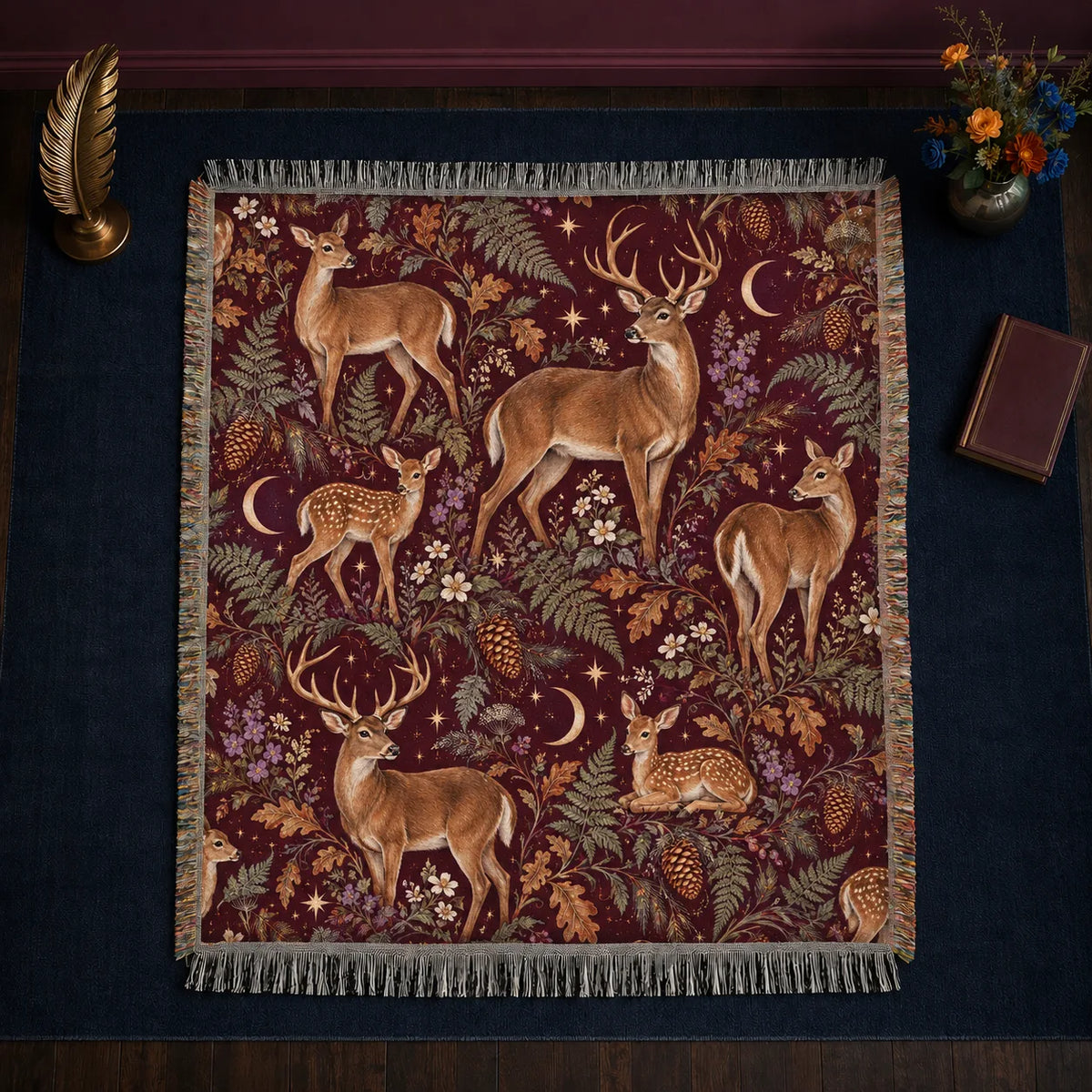 Burgundy Night Deer woven throw blanket — tan deer and resting fawns among ferns, oak leaves and gold crescent moons on burgundy