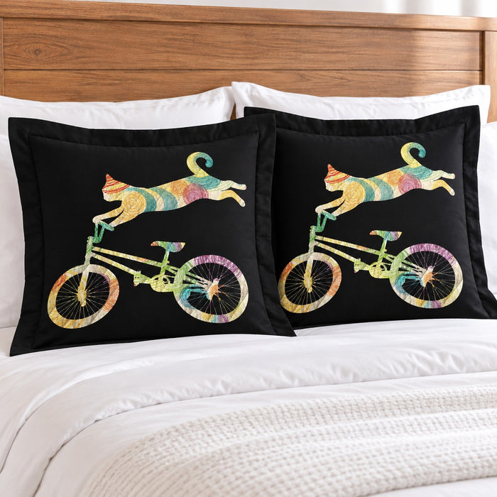 Rainbow Cycling Cat pillow shams – set of two flanged shams against a wooden headboard