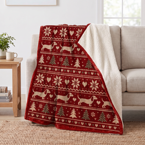 Fair Isle Dachshund Christmas sherpa blanket draped over a sofa, corner folded back to show the cream sherpa reverse