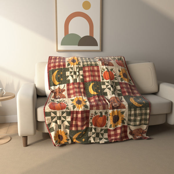Autumn Plaid Highland Cow Patchwork fleece throw blanket draped over a sofa
