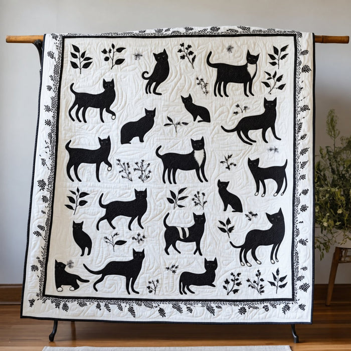 Black & White Silhouette Cats quilt – white quilt with black cat silhouettes and leafy sprigs in monochrome