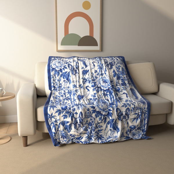 Chinoiserie French Bulldog fleece throw blanket draped over a sofa