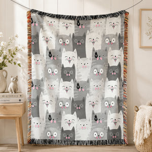 Grey Kawaii Cat Woven Throw Blanket on a made bed