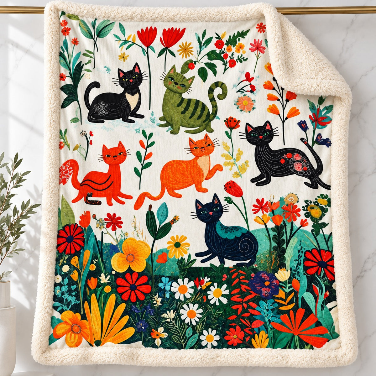 Meadow Play Cats sherpa fleece blanket – printed flannel front with plush cream sherpa back, hanging on a gold rod