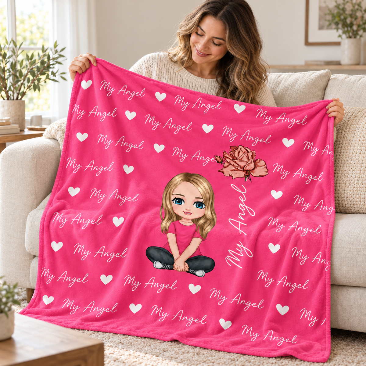 Woman holding the My Angel personalised name blanket in a bright living room