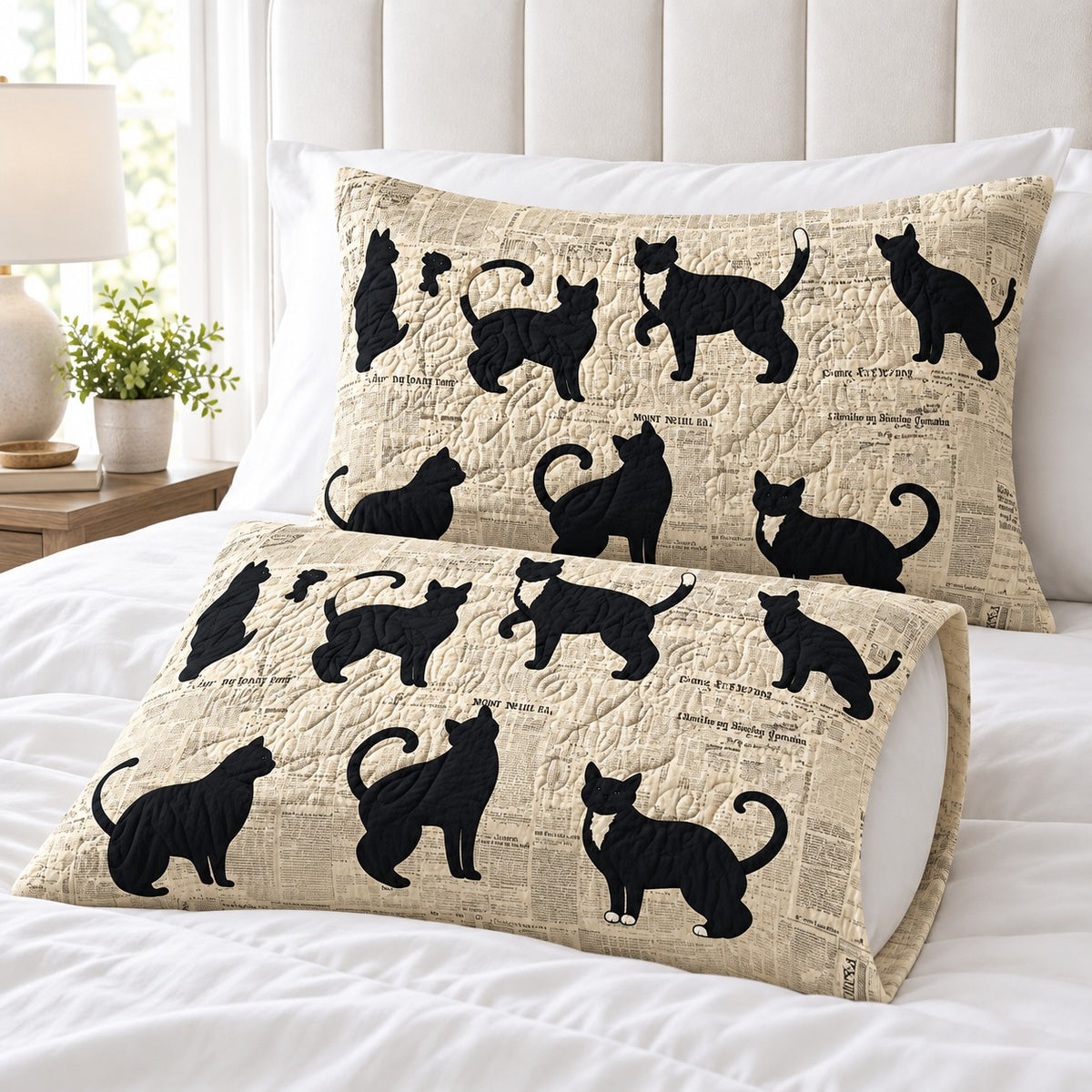 Newsprint Black Cats pillowcases – set of two printed envelope pillowcases on a white bed