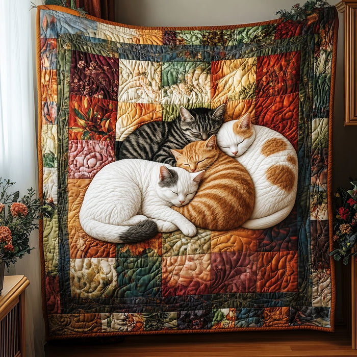 Patchwork Cat Nap quilt – patchwork quilt in earthy squares with three cats curled up asleep in the centre