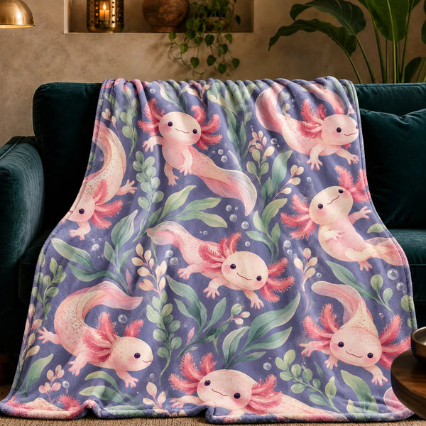 Periwinkle Pond Axolotl fleece throw blanket — smiling pink axolotls among sage leaves, blush sprigs and bubbles on dusty periwinkle