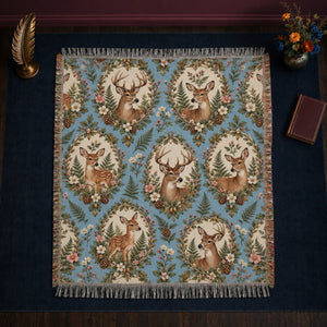 Botanical Medallions Deer woven throw blanket — deer and fawns in cream ovals framed by leaves, pink blossoms and pinecones on blue