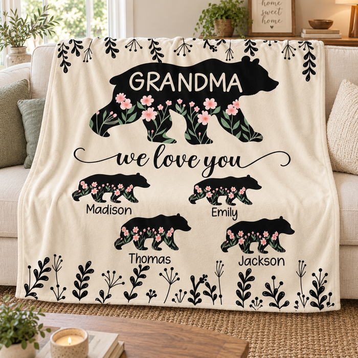 Grandma Bear personalised name blanket with floral bear silhouettes, on a sofa