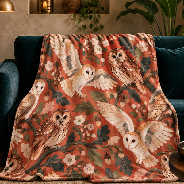 Terracotta Modern Owl fleece throw blanket — cream barn owls and tawny owls among dark green oak leaves and blossoms on terracotta