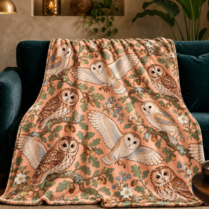 Whimsical Contour Owl fleece throw blanket — outlined barn and tawny owls with sage oak leaves, acorns and blue flowers on peach