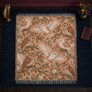 Whimsical Contour Owl woven throw blanket — outlined barn and tawny owls with sage oak leaves, acorns and blue flowers on peach