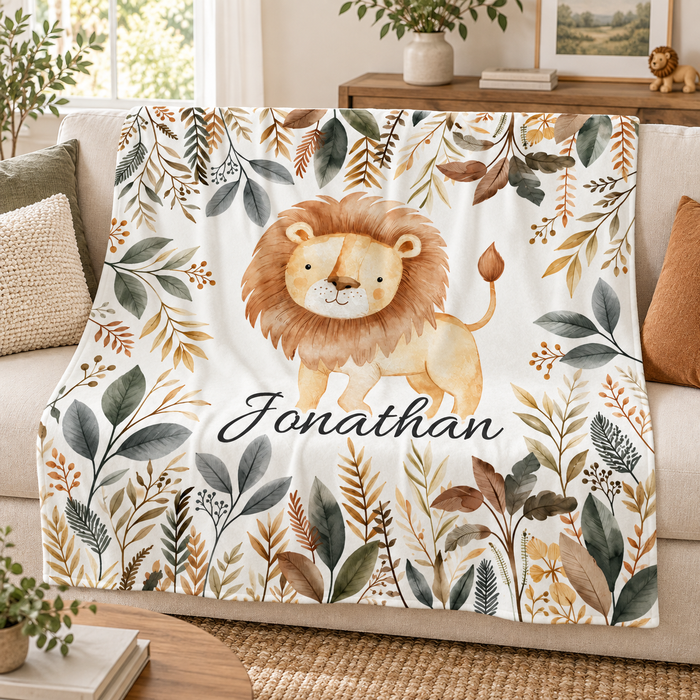 Safari lion personalised name blanket with foliage border, on a sofa